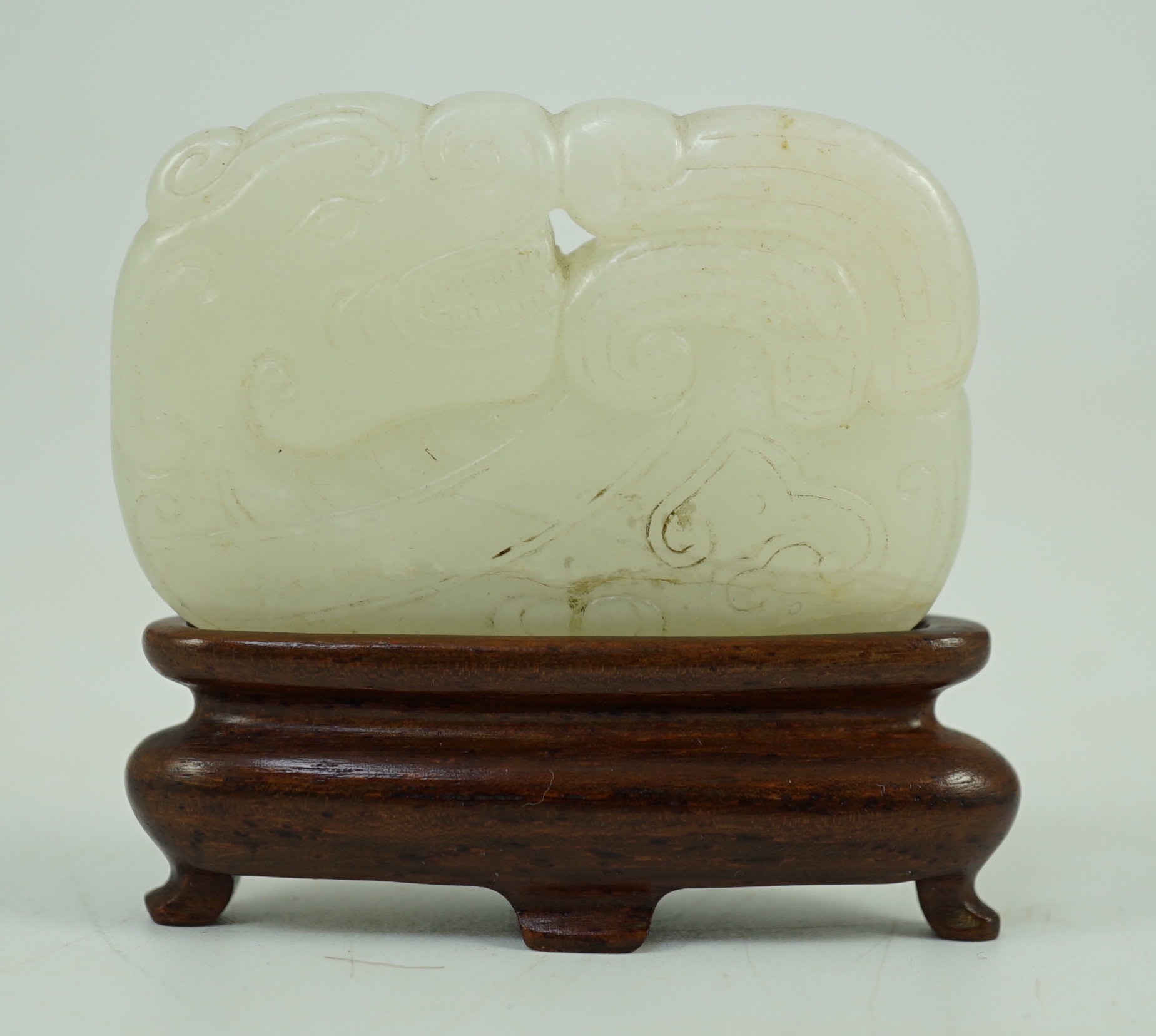 A Chinese white jade ‘tiger and dragon’ plaque, 18th/19th century 5.1 cm wide, wood stand